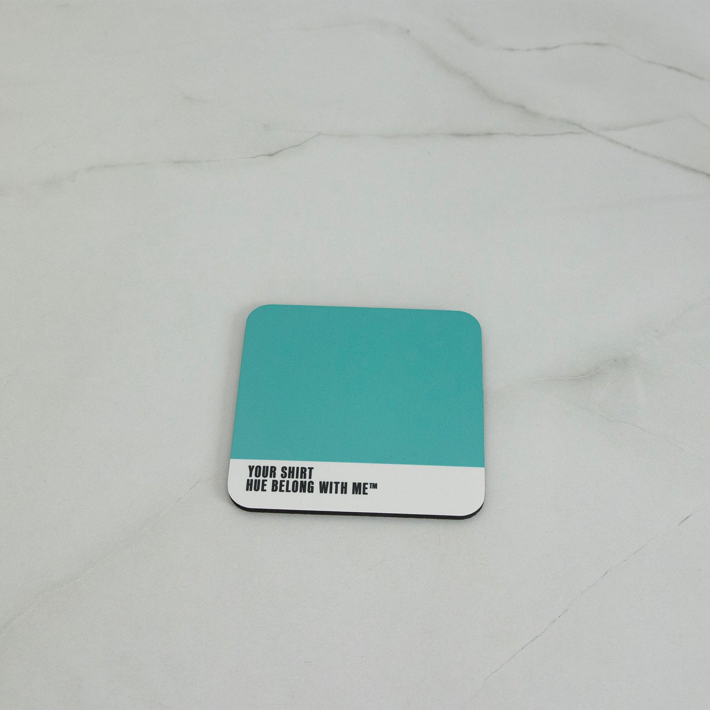 Crisp high-contrast teal cork-back coaster, flat lay on marble counter — Your Shirt by Hue Belong With Me